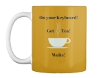 yellow tea mug with white cup on it. Black writing says: "On your Keyboard! Get Tea! Write!